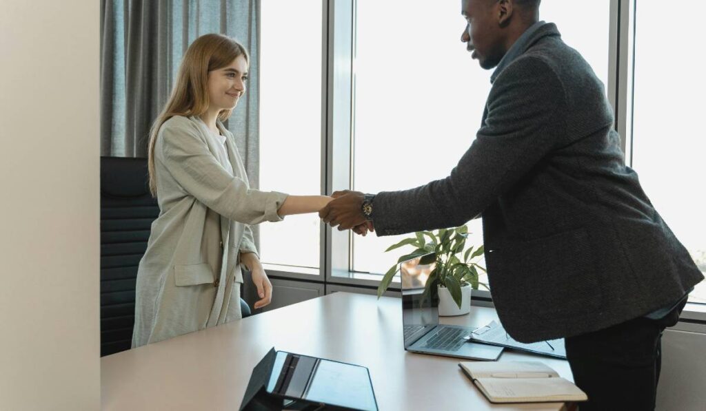 A real estate agent advises a woman interested in buying a house.