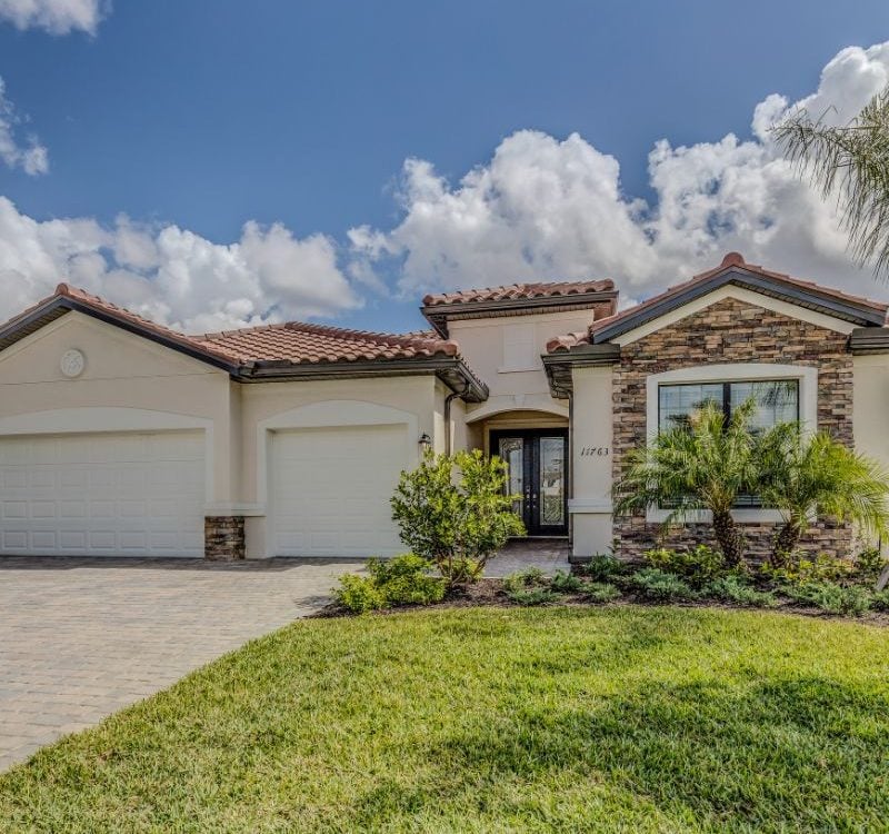 Casa junto al lago en Orlando, rodeada de árboles y con vista al agua tranquila.