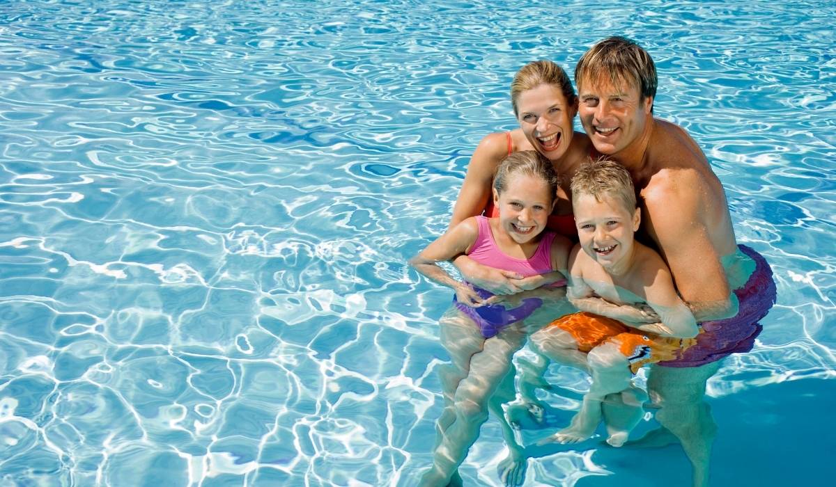 A happy family enjoying time together in a pool, highlighting Orlando's appeal as a fun investment destination