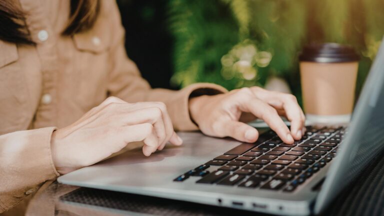 Propietario utilizando una computadora portátil para gestionar el calendario y las reservas de su renta vacacional en Florida desde el extranjero.