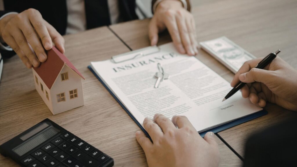 Propietario firmando un contrato de seguro para vivienda vacacional para proteger su inversión inmobiliaria.